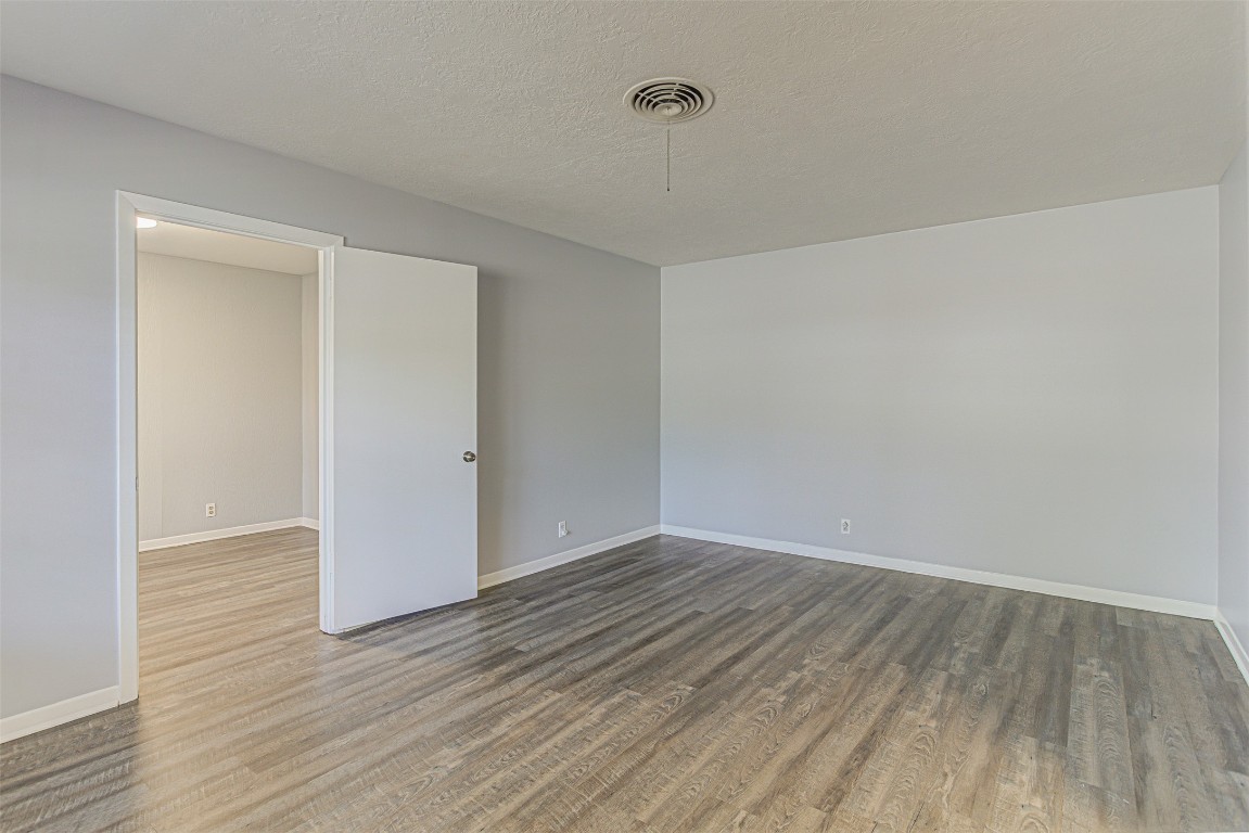 2001 Oakglen Drive Austin, TX 78745 - Photo 5 of 40 a view of an empty room with wooden floor