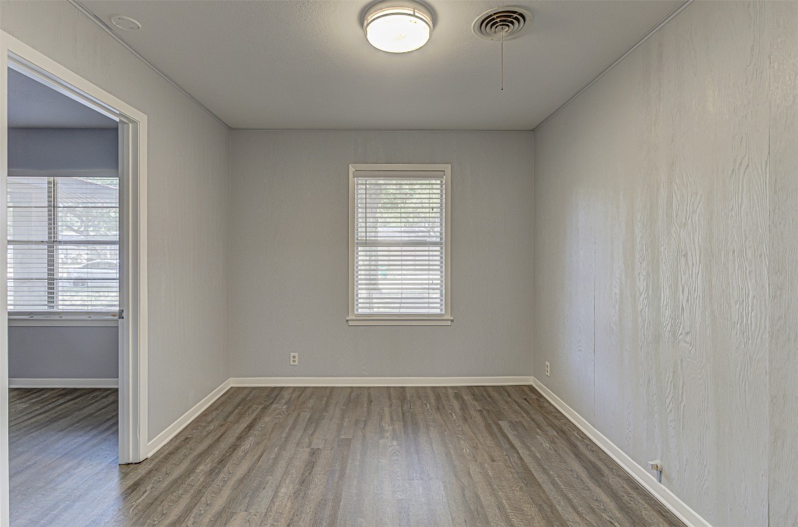 2001 Oakglen Drive Austin, TX 78745 - Photo 8 of 40 an empty room with wooden floor and windows