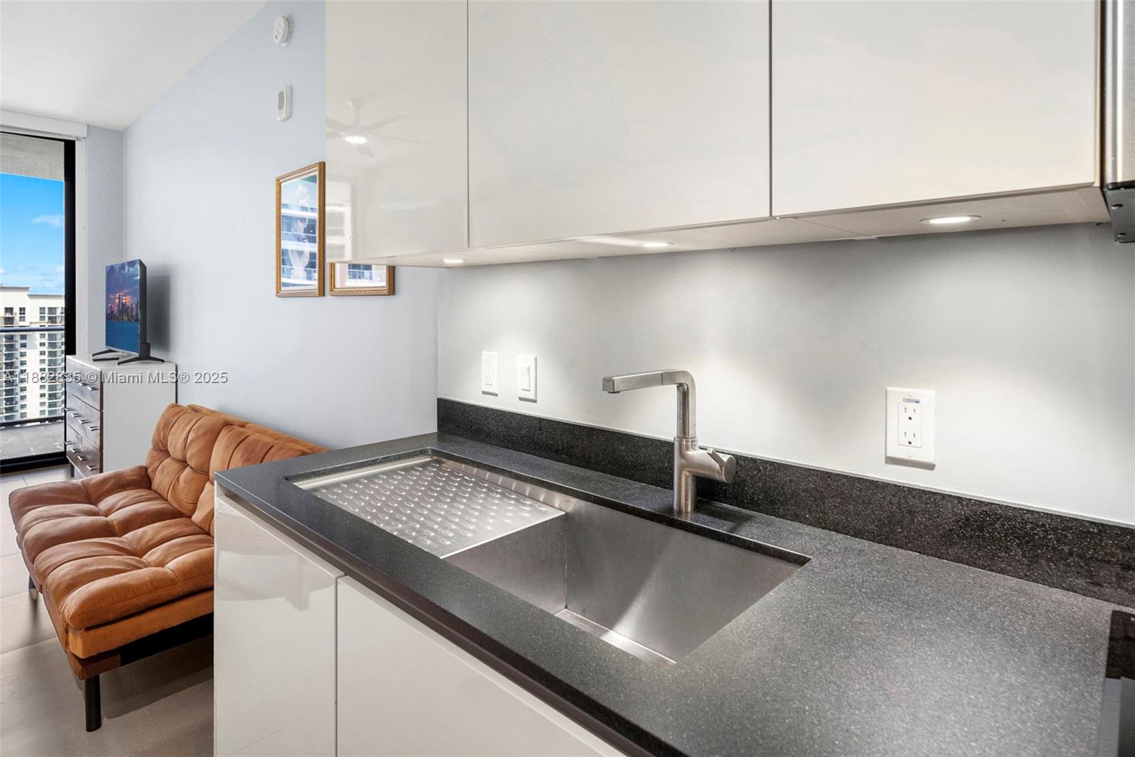 1010 Brickell Avenue, Unit 3610 Miami, FL 33131 - Photo 16 of 37 a kitchen with a sink cabinets and a counter top