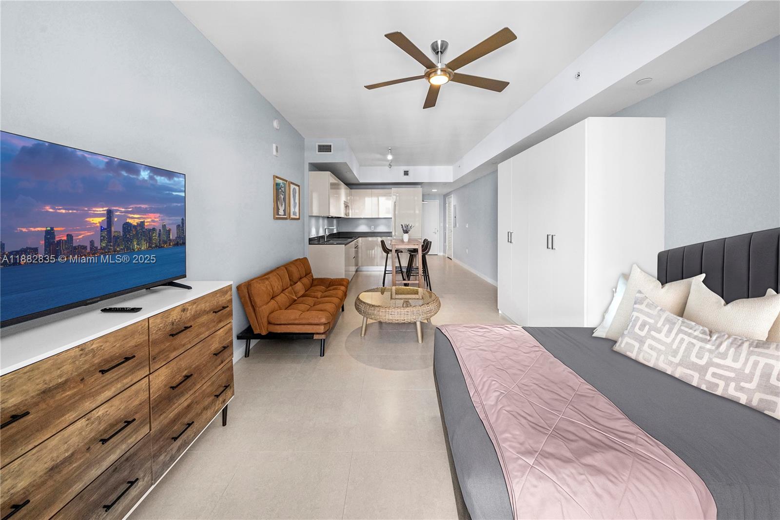 1010 Brickell Avenue, Unit 3610 Miami, FL 33131 - Photo 2 of 37 a living room with furniture and a flat screen tv