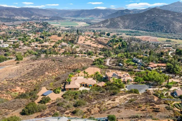 an aerial view of residential house and covered with trees