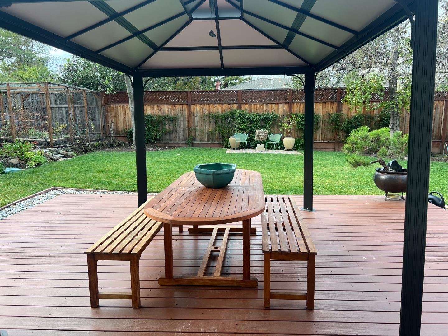 2198 Avy Avenue Menlo Park, CA 94025 - Photo 24 of 28 a view of a patio with a table chairs and a backyard