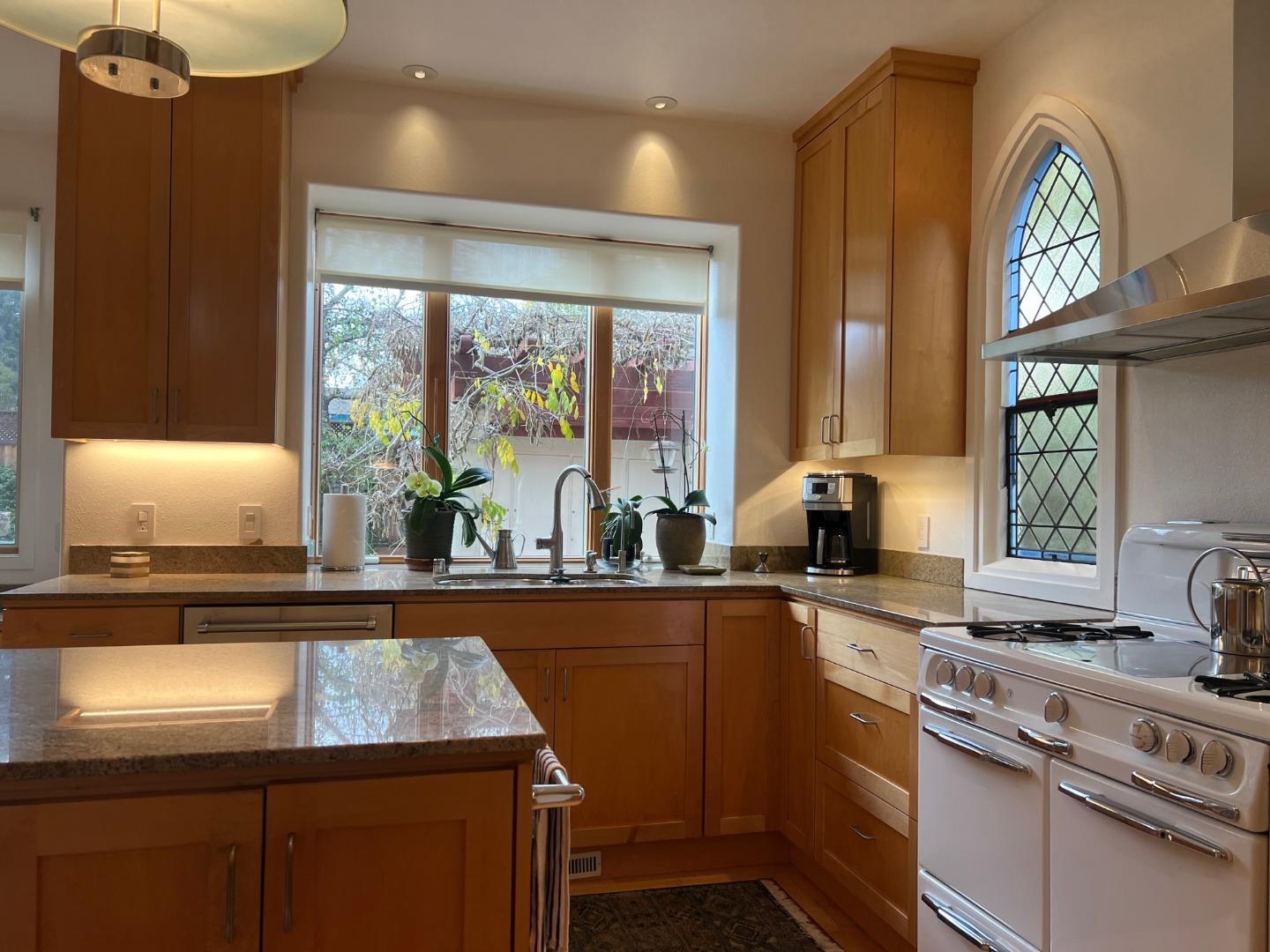 2198 Avy Avenue Menlo Park, CA 94025 - Photo 7 of 28 a kitchen with stainless steel appliances granite countertop a sink a stove and a microwave