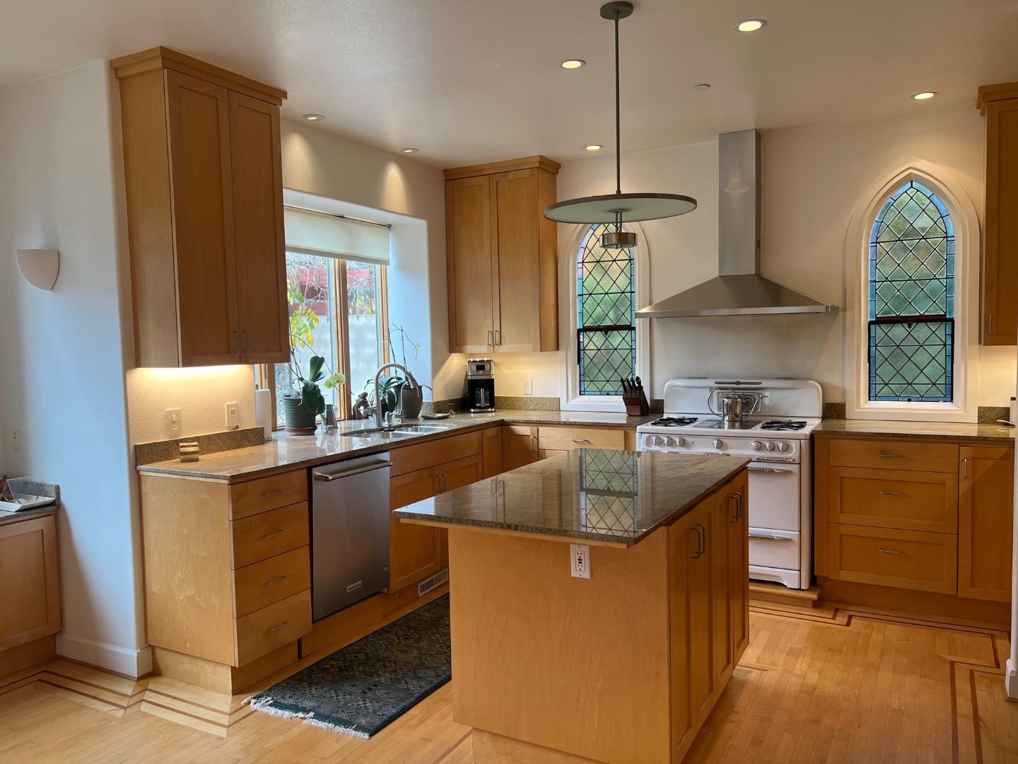 2198 Avy Avenue Menlo Park, CA 94025 - Photo 8 of 28 a kitchen with kitchen island granite countertop a sink stove and refrigerator