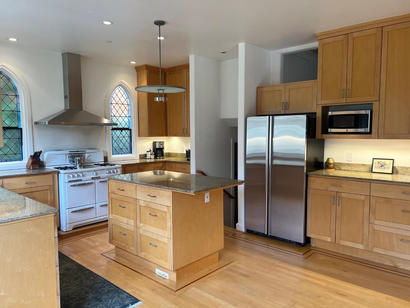 2198 Avy Avenue Menlo Park, CA 94025 - Photo 9 of 28 a kitchen with stainless steel appliances granite countertop a sink a stove and a refrigerator