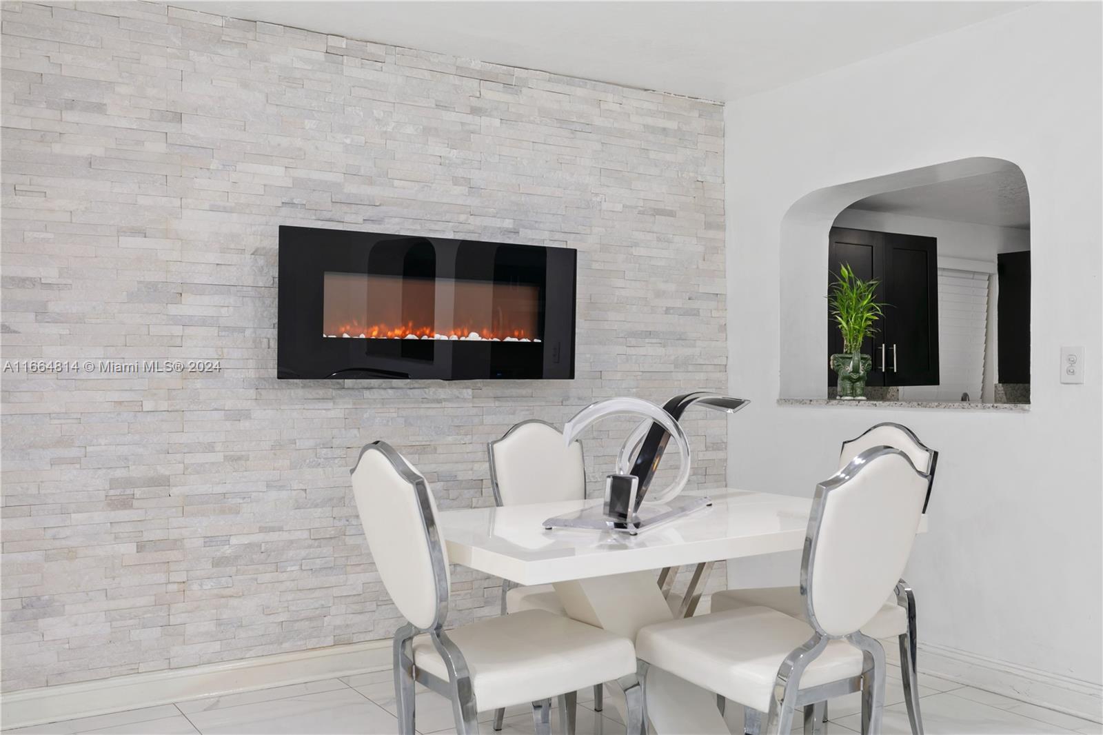 750 East 55th Street Hialeah, FL 33013 - Photo 12 of 66 a living room with couches chairs and a fireplace