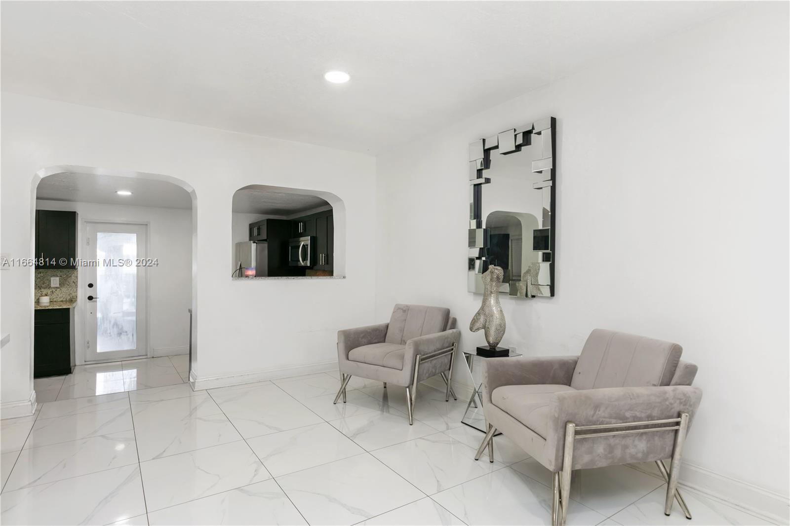 750 East 55th Street Hialeah, FL 33013 - Photo 13 of 66 a living room with furniture and a view of kitchen