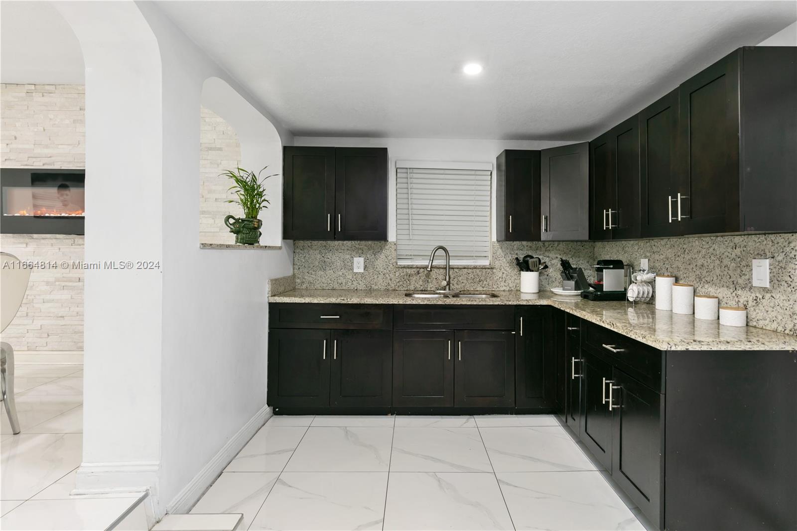 750 East 55th Street Hialeah, FL 33013 - Photo 19 of 66 a kitchen with a sink and cabinets