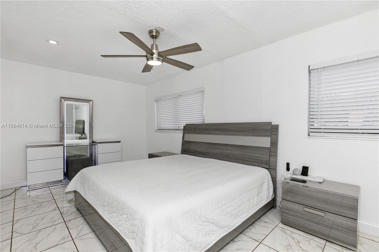750 East 55th Street Hialeah, FL 33013 - Photo 20 of 66 a bedroom with a bed and a ceiling fan