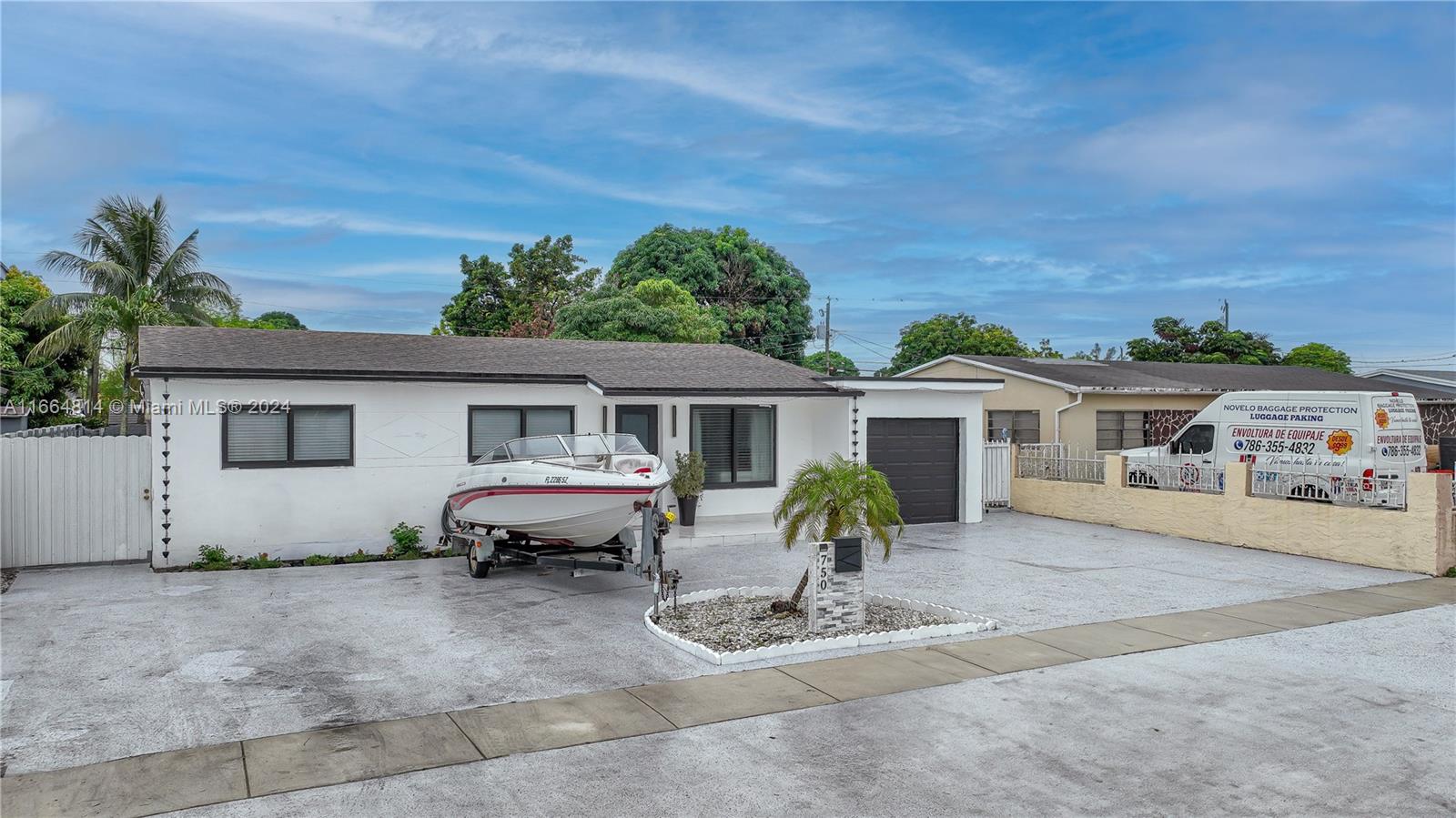 750 East 55th Street Hialeah, FL 33013 - Photo 2 of 66 a house view with a sitting space fire pit and outdoor space