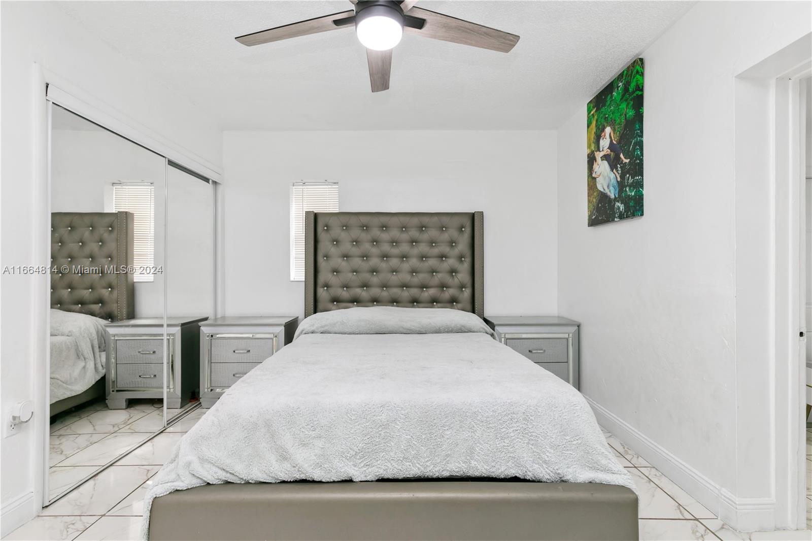 750 East 55th Street Hialeah, FL 33013 - Photo 24 of 66 a bedroom with a large bed and a chandelier