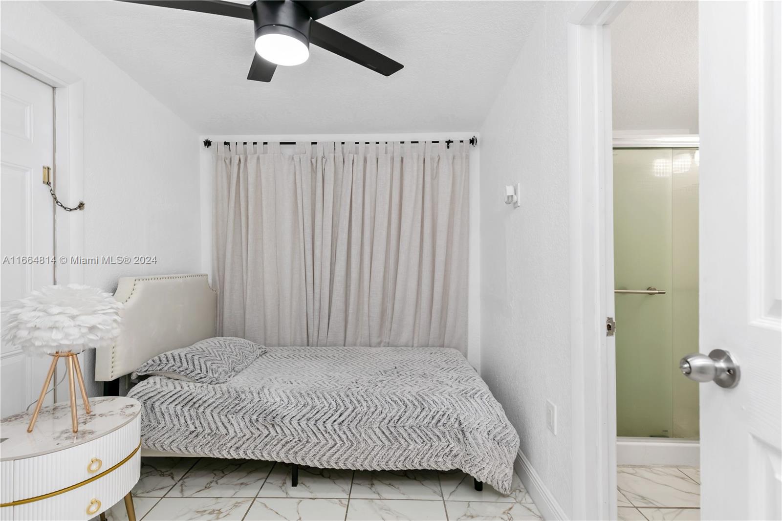 750 East 55th Street Hialeah, FL 33013 - Photo 25 of 66 a bedroom with a bed and a chandelier
