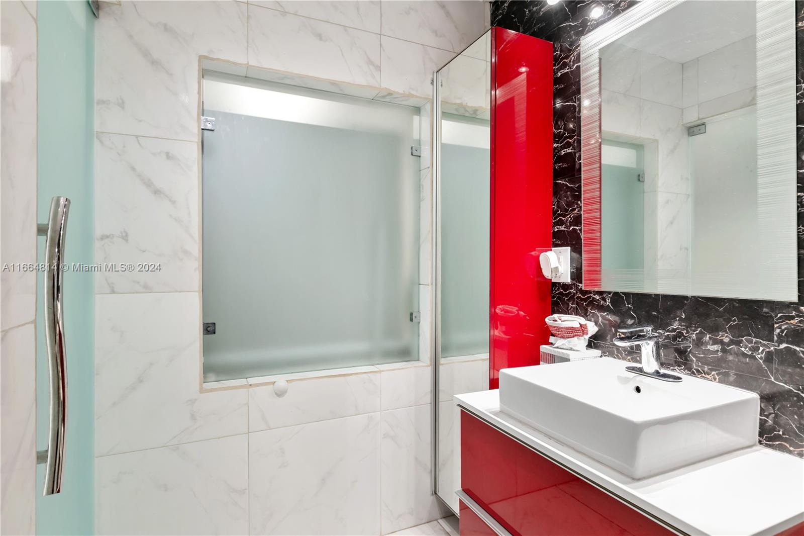750 East 55th Street Hialeah, FL 33013 - Photo 29 of 66 a bathroom with a sink vanity and shower
