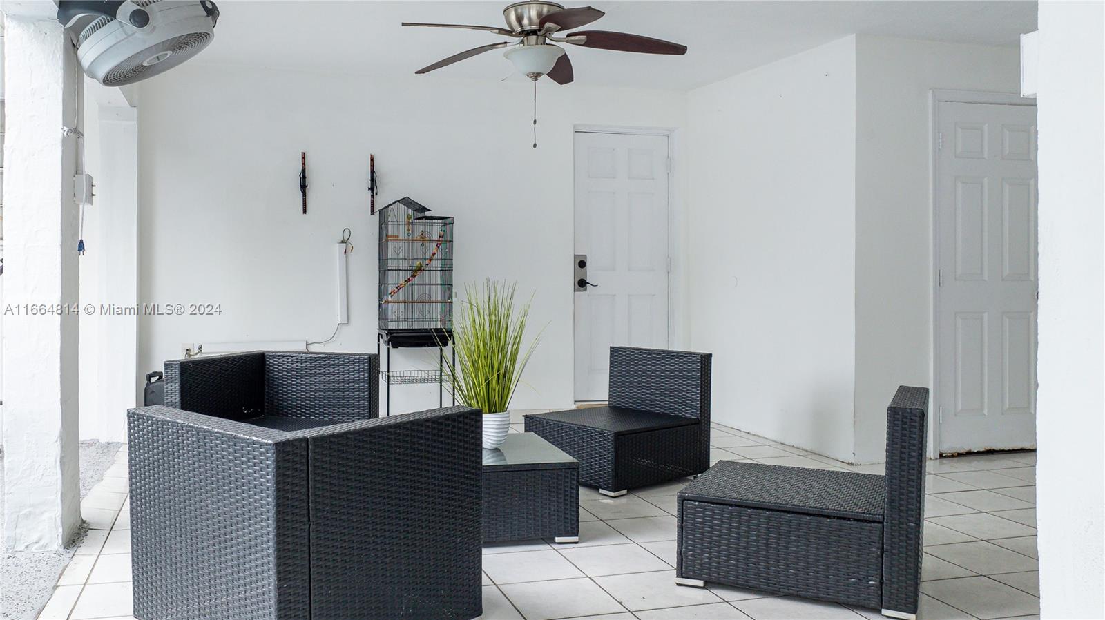 750 East 55th Street Hialeah, FL 33013 - Photo 34 of 66 a living room with furniture and a lamp