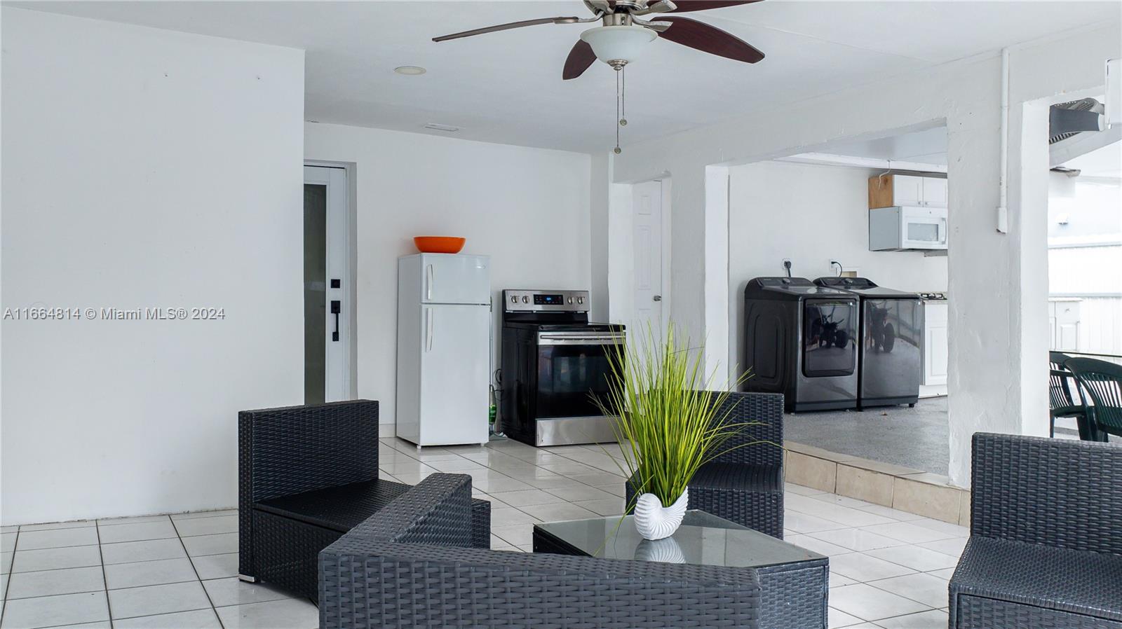 750 East 55th Street Hialeah, FL 33013 - Photo 35 of 66 a living room with furniture and a fireplace