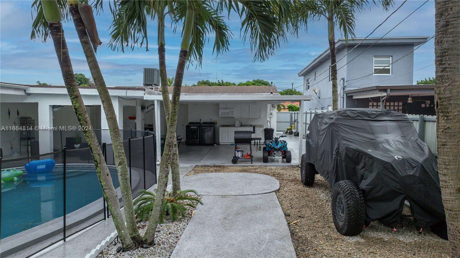750 East 55th Street Hialeah, FL 33013 - Photo 39 of 66 a front view of a house with garden and patio