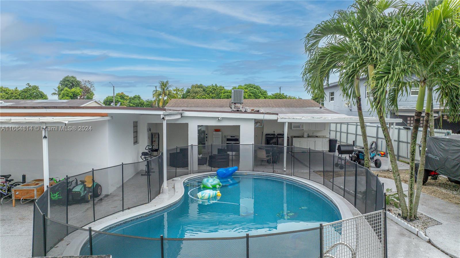 750 East 55th Street Hialeah, FL 33013 - Photo 41 of 66 swimming pool view with a seating space and a garden