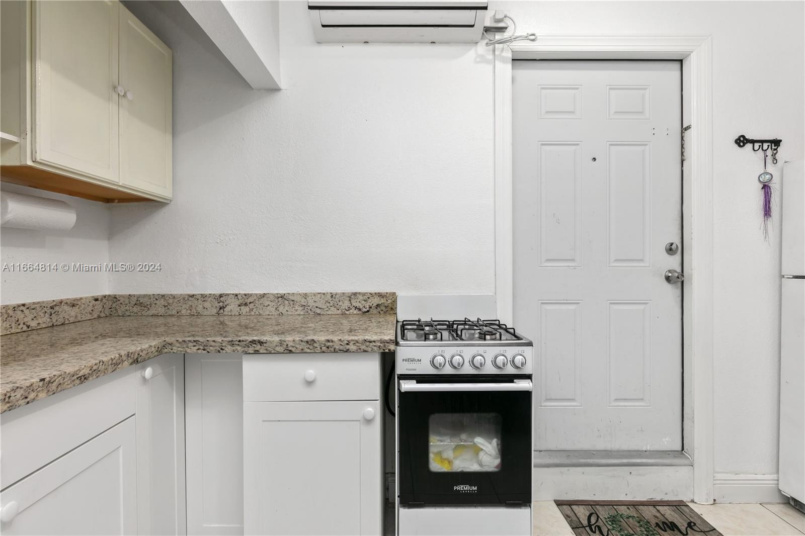 750 East 55th Street Hialeah, FL 33013 - Photo 50 of 66 a kitchen with granite countertop a sink stove and cabinets