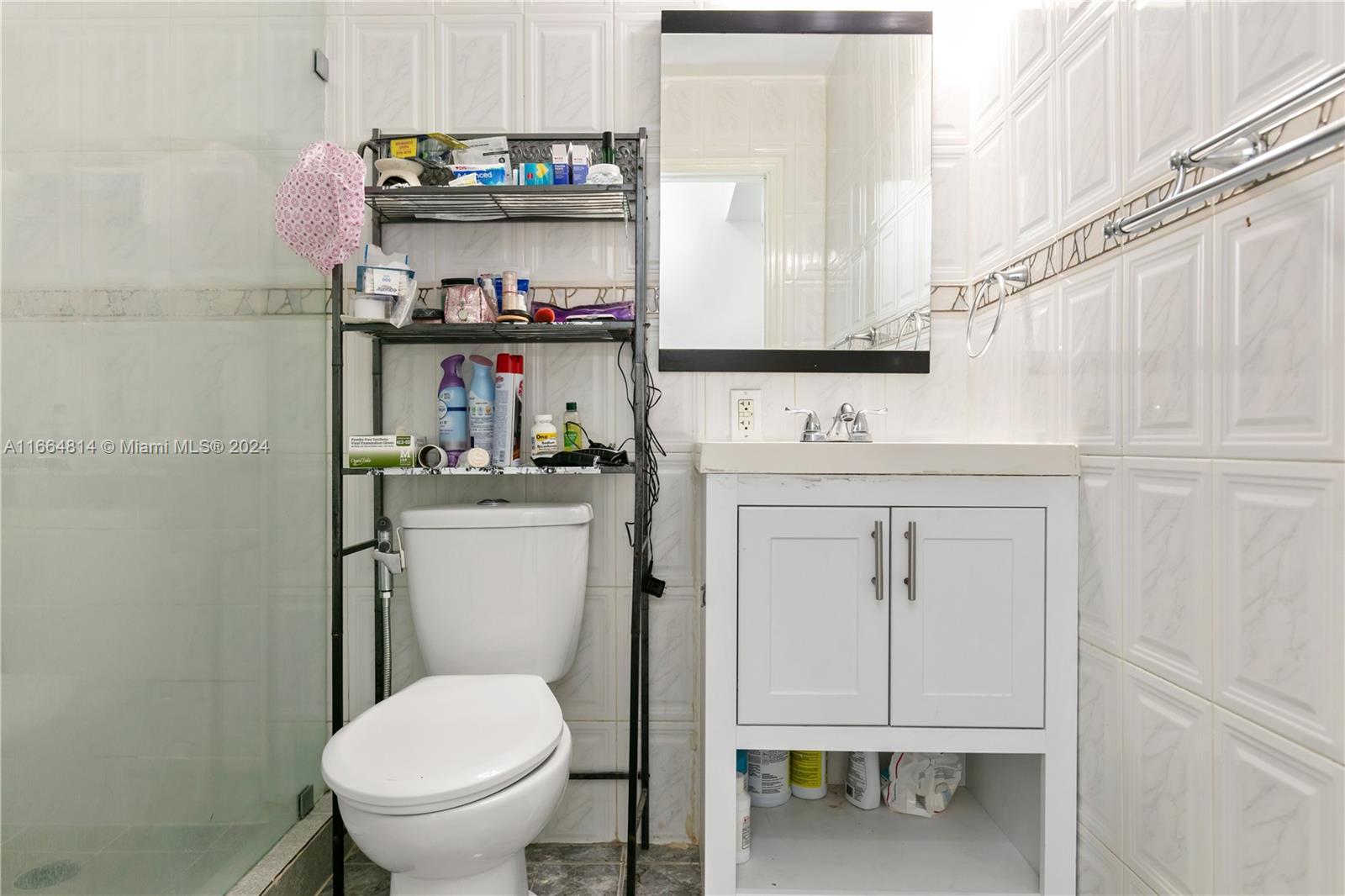 750 East 55th Street Hialeah, FL 33013 - Photo 56 of 66 a bathroom with a toilet a sink and a window