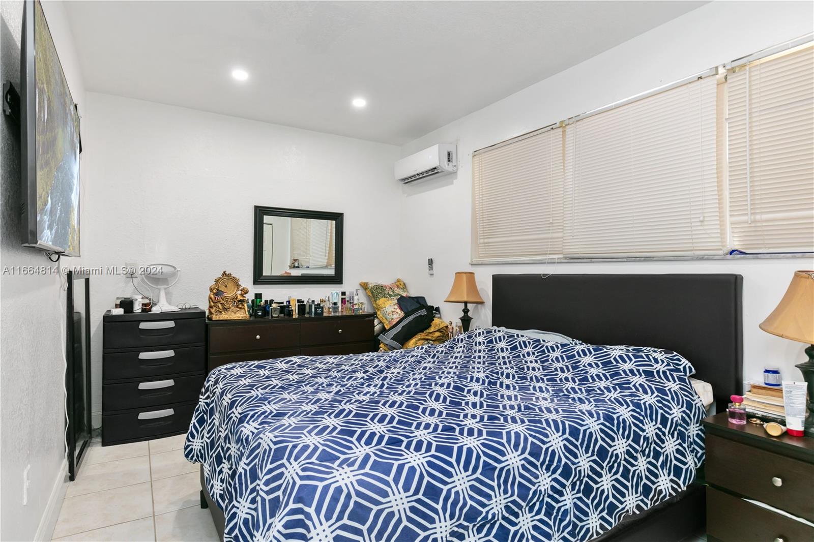 750 East 55th Street Hialeah, FL 33013 - Photo 58 of 66 a bedroom with a bed and a lamp on dresser