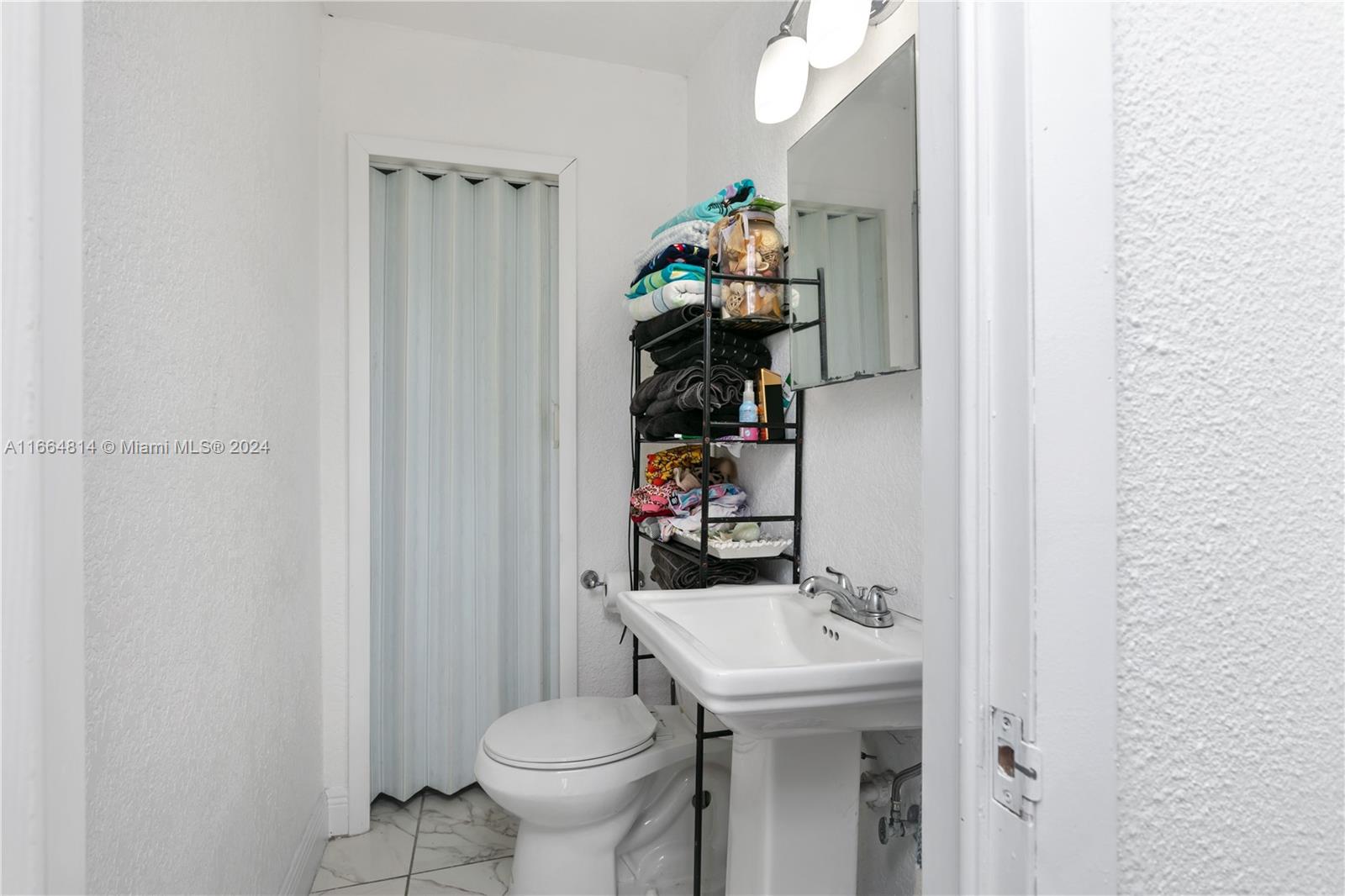 750 East 55th Street Hialeah, FL 33013 - Photo 59 of 66 a bathroom with a sink toilet and vanity