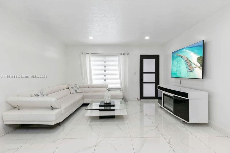 750 East 55th Street Hialeah, FL 33013 - Photo 6 of 66 a living room with furniture and a flat screen tv