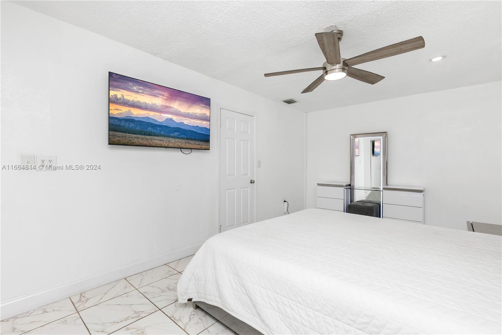 750 East 55th Street Hialeah, FL 33013 - Photo 61 of 66 a bedroom with a bed and a painting on the wall