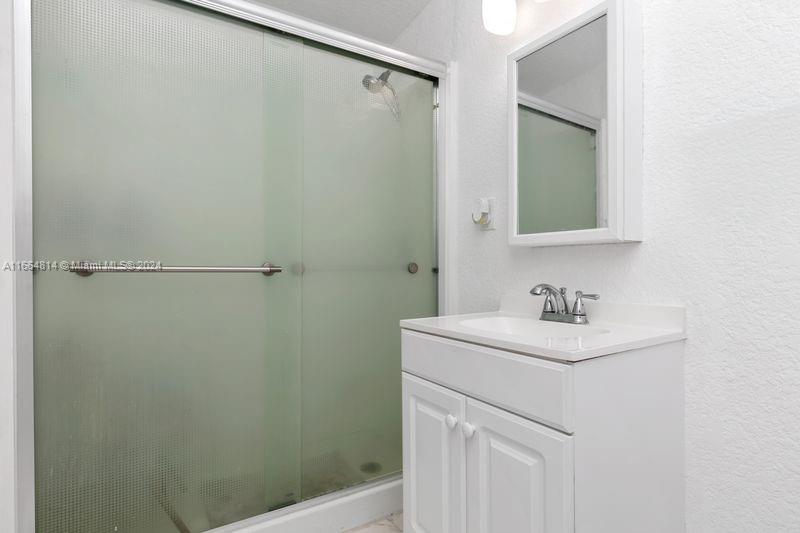 750 East 55th Street Hialeah, FL 33013 - Photo 62 of 66 a bathroom with a sink a toilet and a mirror