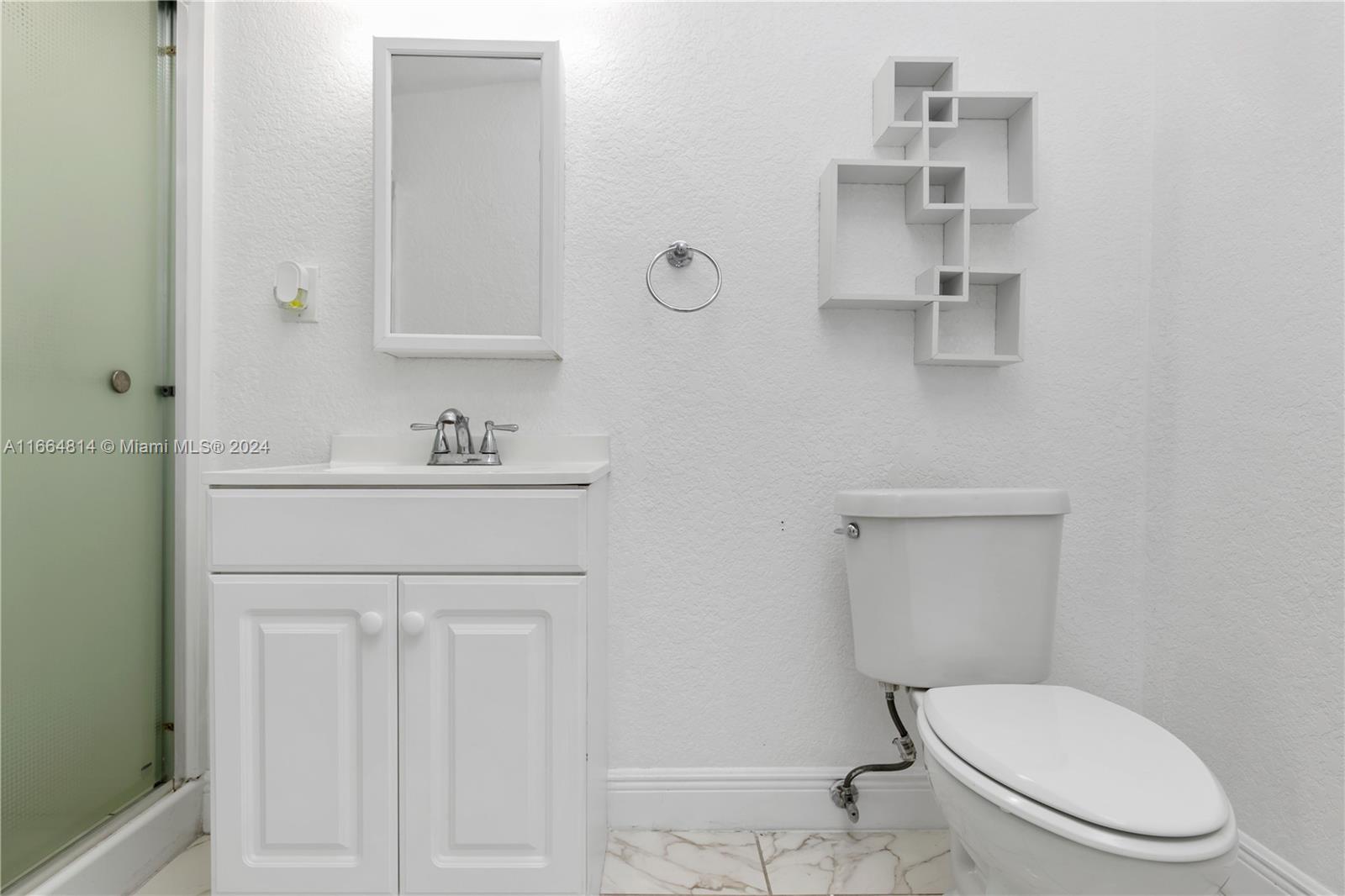 750 East 55th Street Hialeah, FL 33013 - Photo 63 of 66 a bathroom with a sink toilet and vanity