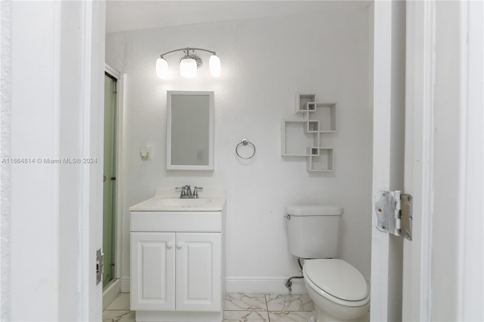 750 East 55th Street Hialeah, FL 33013 - Photo 64 of 66 a bathroom with a sink toilet vanity and mirror