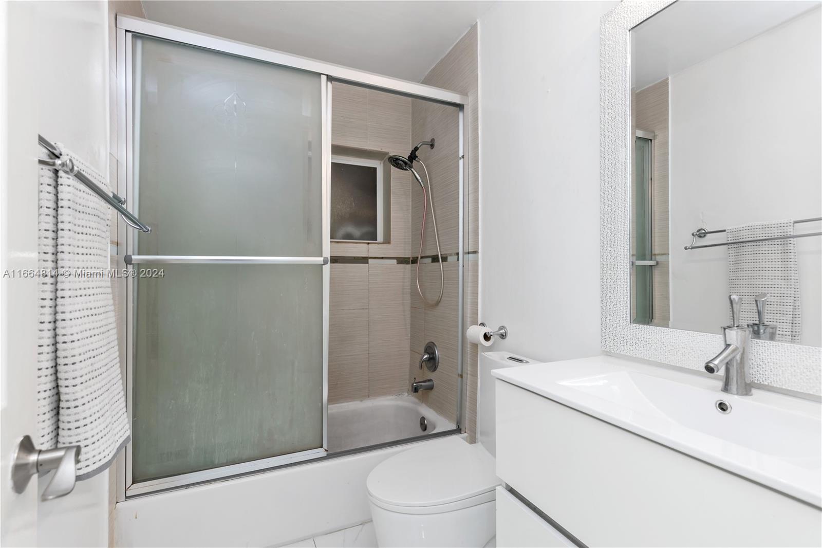 750 East 55th Street Hialeah, FL 33013 - Photo 66 of 66 a bathroom with a shower a sink and a toilet