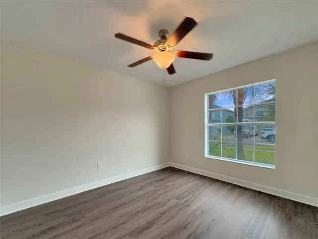 wooden floor in an empty room with a window