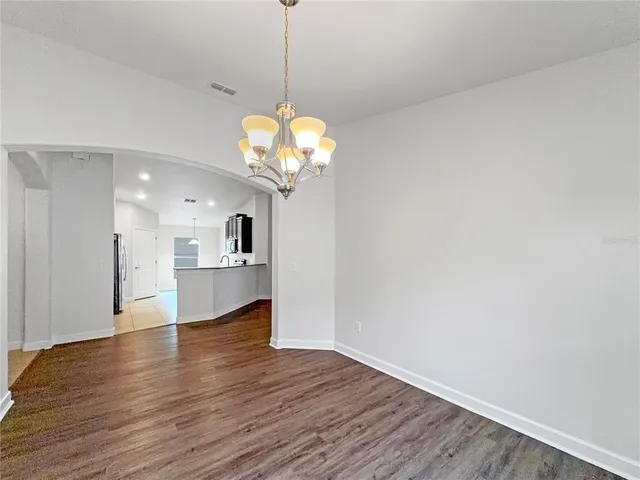a view of a kitchen with wooden floor and a kitchen