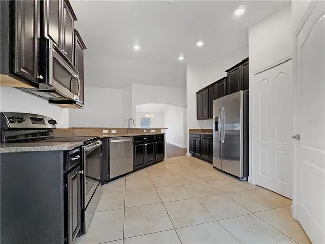a kitchen with a refrigerator and a sink