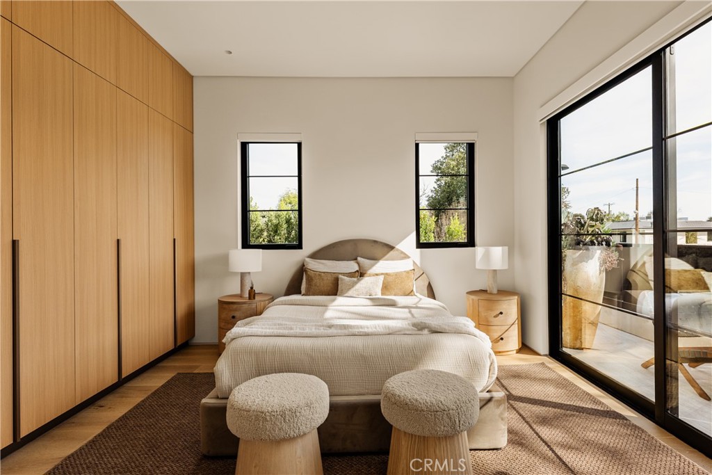 11937 Addison Street Valley Village, CA 91607 - Photo 12 of 48 a bedroom with a bed and wooden floor
