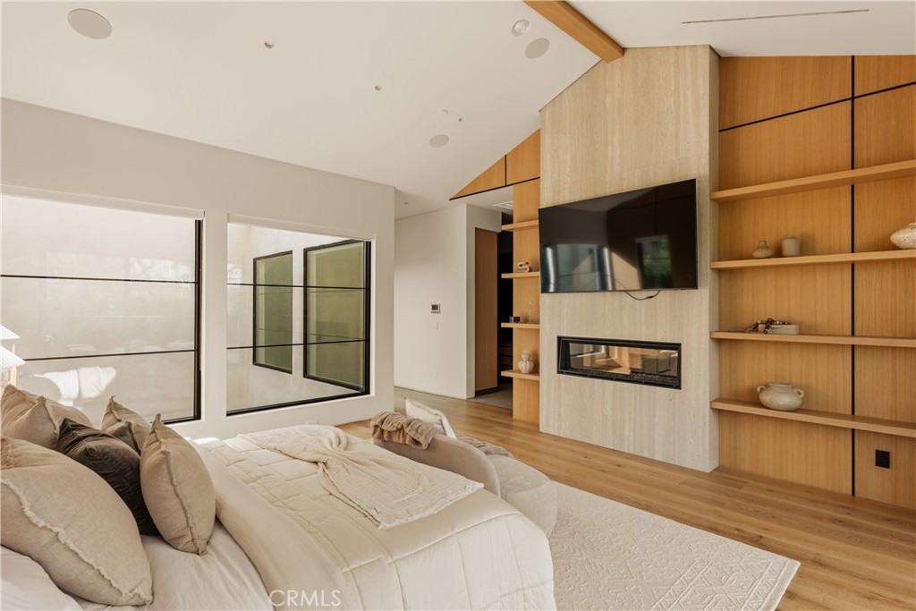 11937 Addison Street Valley Village, CA 91607 - Photo 17 of 48 a spacious bedroom with a bed a mirror and windows