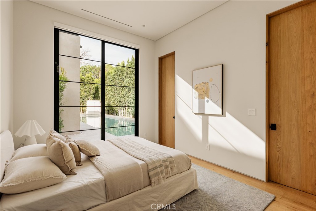 11937 Addison Street Valley Village, CA 91607 - Photo 26 of 48 a bedroom with a bed and a large window