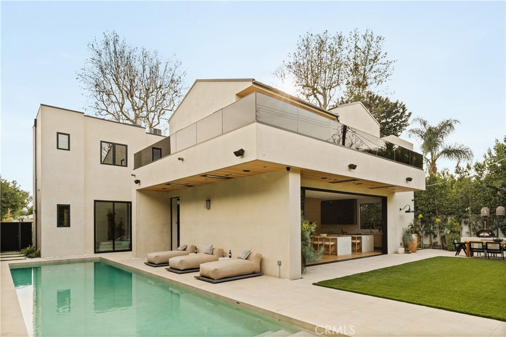 11937 Addison Street Valley Village, CA 91607 - Photo 41 of 48 a view of a white house with a chairs in a patio