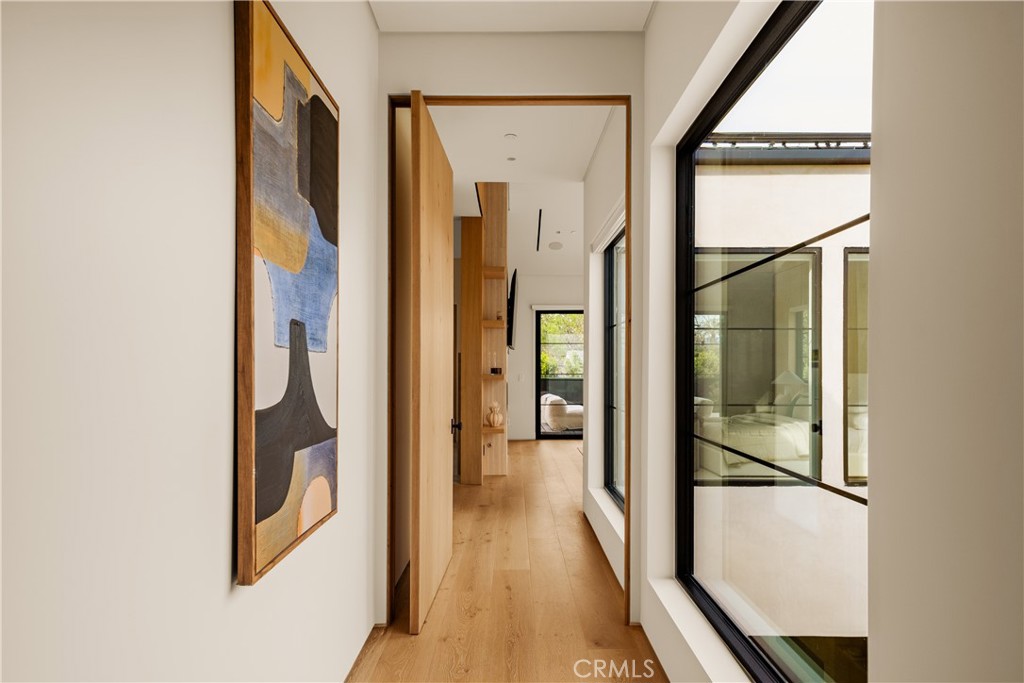 11937 Addison Street Valley Village, CA 91607 - Photo 10 of 48 a view of a hallway with wooden floor and staircase