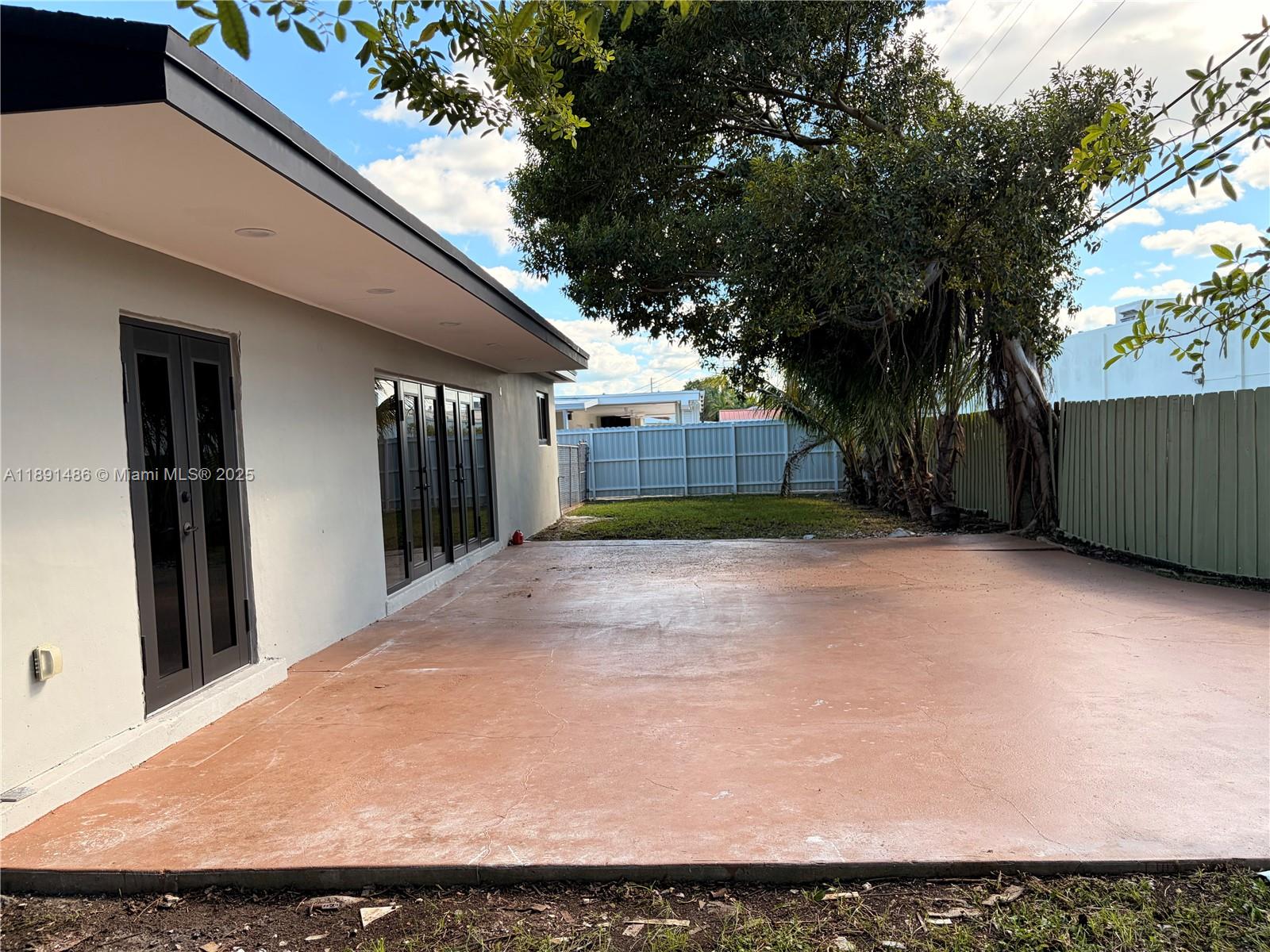 2120 Southwest 84th Avenue Miami, FL 33155 - Photo 5 of 26 a view of backyard with large trees and wooden fence