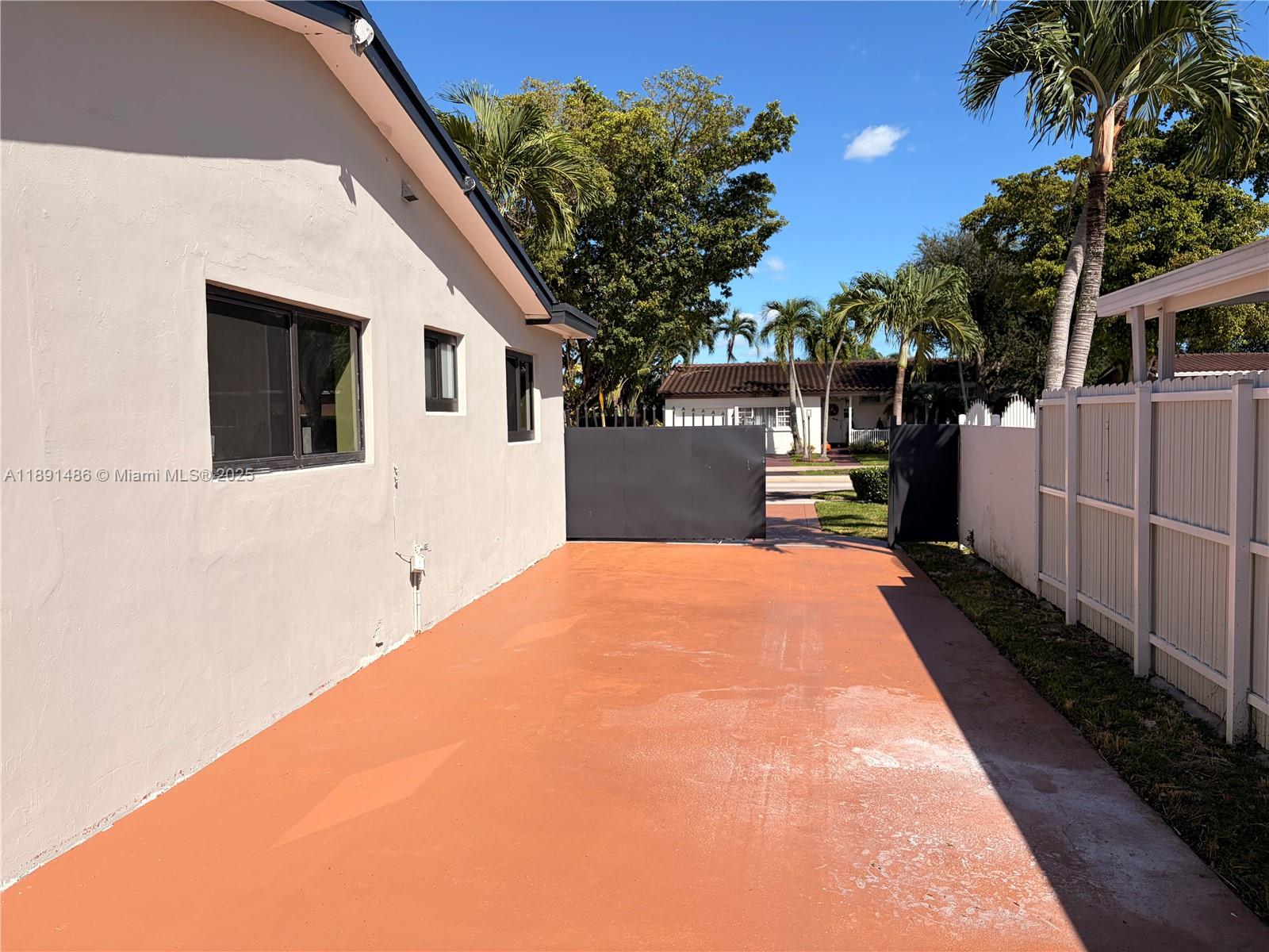2120 Southwest 84th Avenue Miami, FL 33155 - Photo 6 of 26 a front view of a house with a garden
