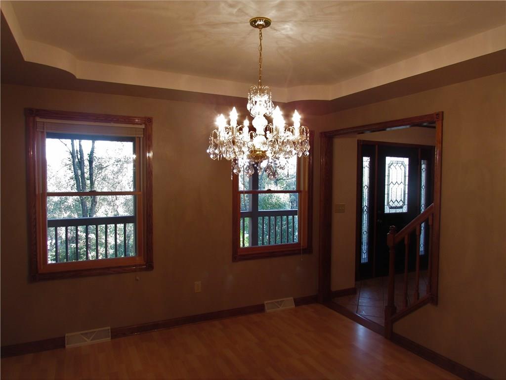 Dining Room with tray ceiling and beautiful chandelier