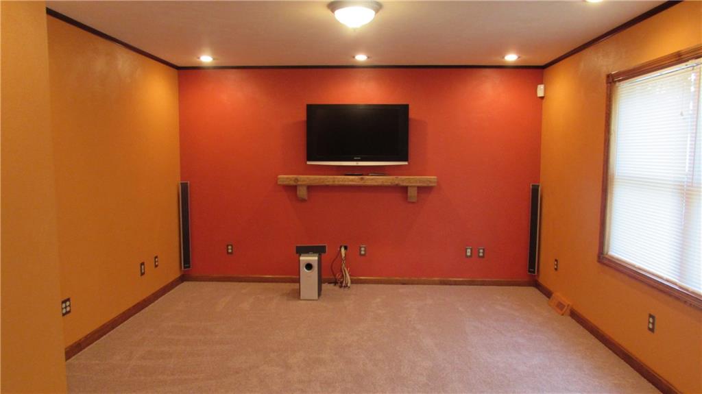 Living Room with new carpet also includes T.V. and Home Theater Speakers