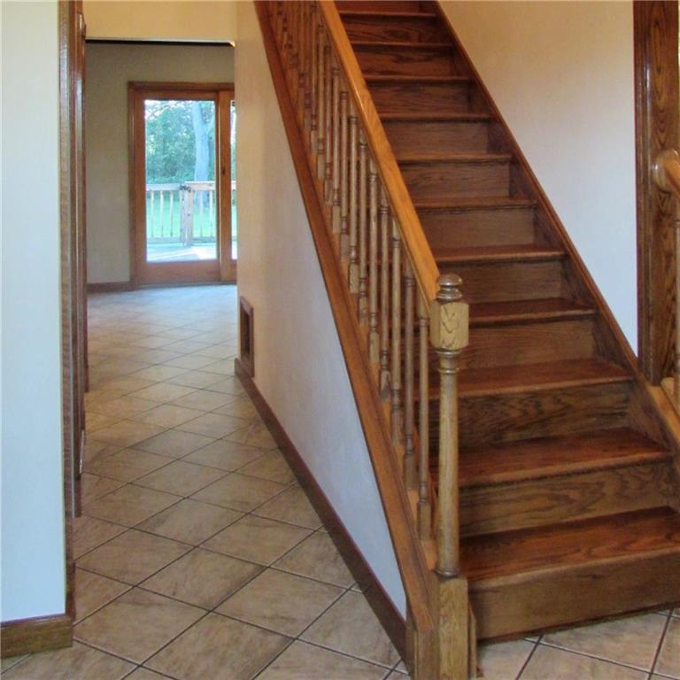289 Buckeye Road Mount Pleasant, PA 15666 - Photo 8 of 25 Custom built oak staircase in Foyer along with ceramic tile flooring