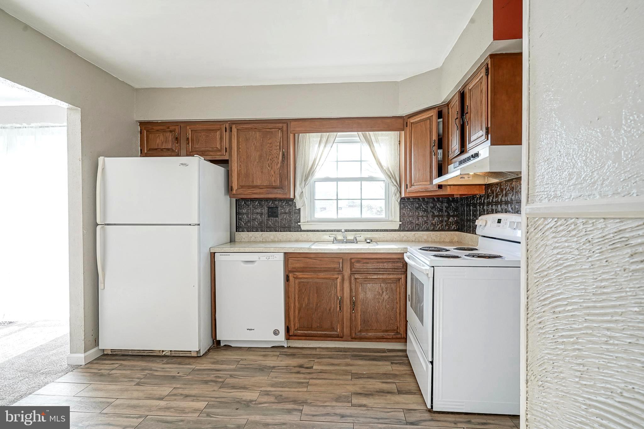 30 Tool Lane Williamstown, NJ 08094 - Photo 11 of 38 a kitchen with stainless steel appliances a refrigerator sink and white cabinets