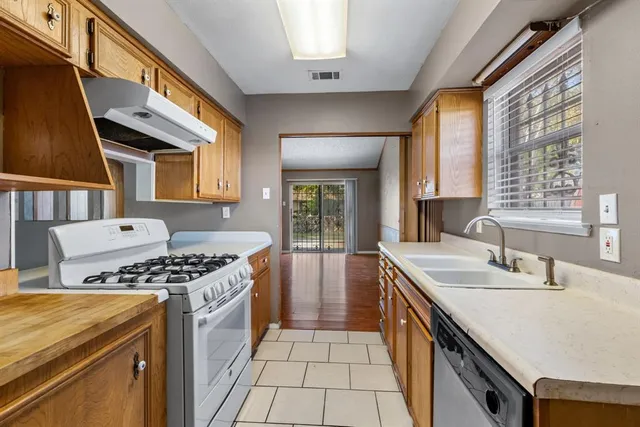 a kitchen that has a sink and a stove