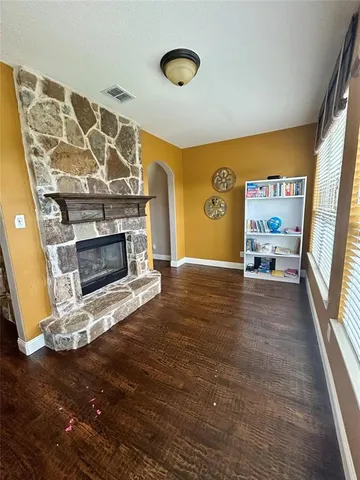 a view of a livingroom with an empty space and a fireplace