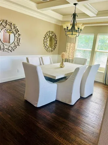 a living room with wooden floor and furniture
