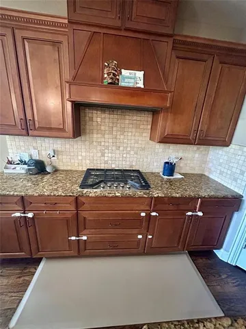 a kitchen with stainless steel appliances granite countertop a stove and a sink