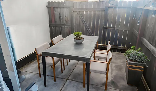 a view of a dining room with furniture and a potted plant